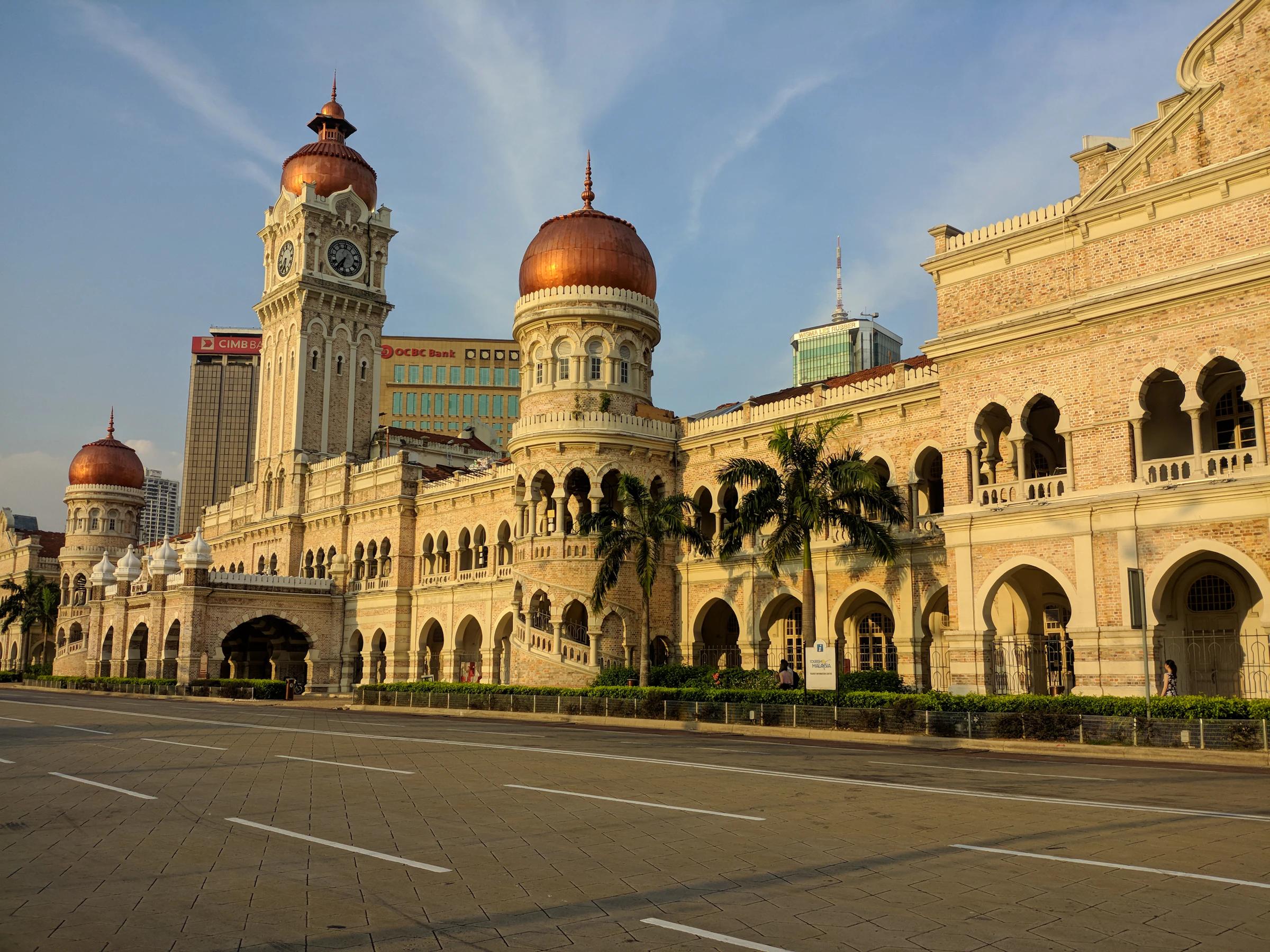 The Sultan Abdul Samad Building on Dataran Merdeka, Kuala Lumpur, its arches and clock tower in late sun.
